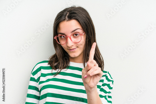 Fototapeta Naklejka Na Ścianę i Meble -  Young caucasian woman wearing a glasses isolated on blue background showing number one with finger.