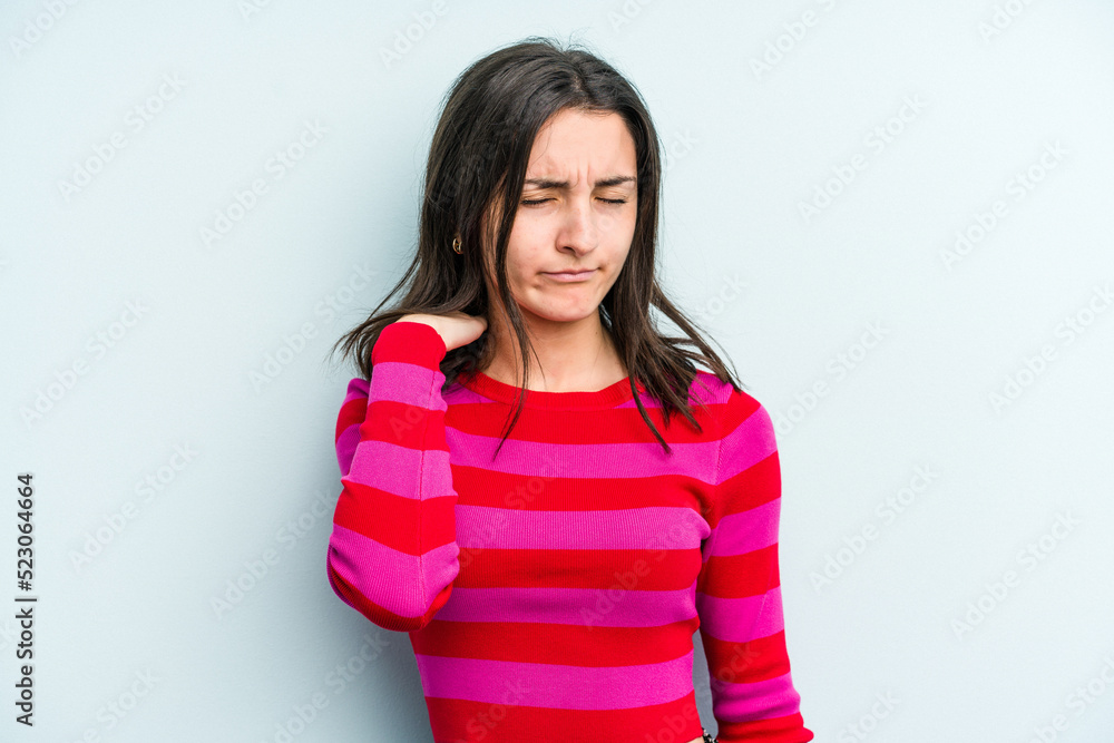 Young caucasian woman isolated on blue background having a neck pain due to stress, massaging and touching it with hand. Young caucasian woman isolated on blue background having a neck pain due to stress, massaging and touching it with hand.