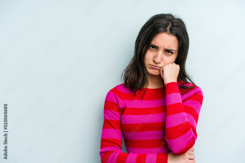 Young caucasian woman isolated on blue background who feels sad and pensive, looking at copy space. Young caucasian woman isolated on blue background who feels sad and pensive, looking at copy space.