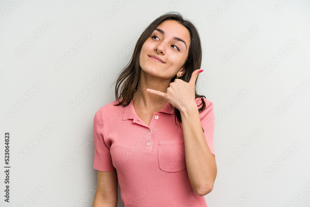 Young caucasian woman isolated on white background showing a mobile phone call gesture with fingers. Young caucasian woman isolated on white background showing a mobile phone call gesture with fingers.