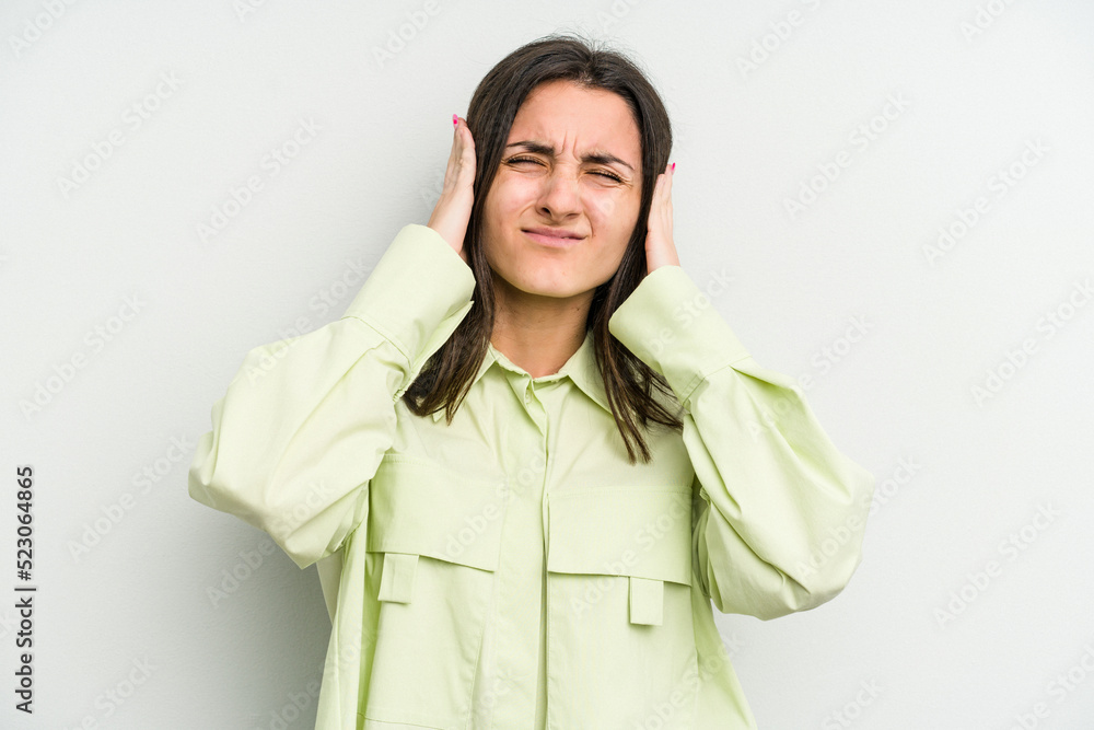 Young caucasian woman isolated on white background covering ears with hands. Young caucasian woman isolated on white background covering ears with hands.