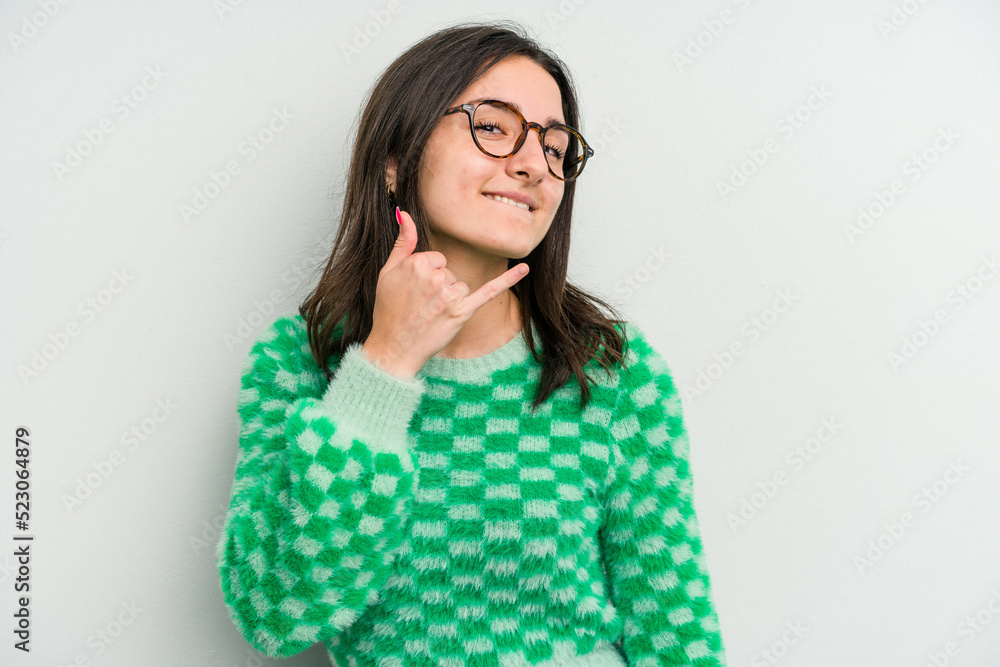 Young caucasian woman isolated on white background showing a mobile phone call gesture with fingers. Young caucasian woman isolated on white background showing a mobile phone call gesture with fingers.