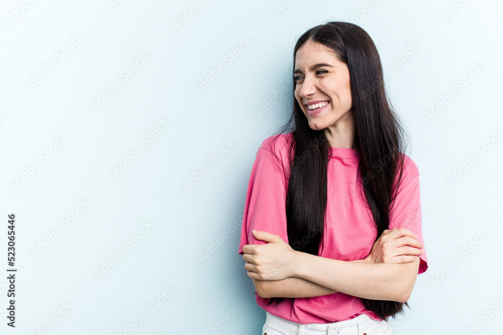 Young caucasian woman isolated on blue background smiling confident with crossed arms. Young caucasian woman isolated on blue background smiling confident with crossed arms.