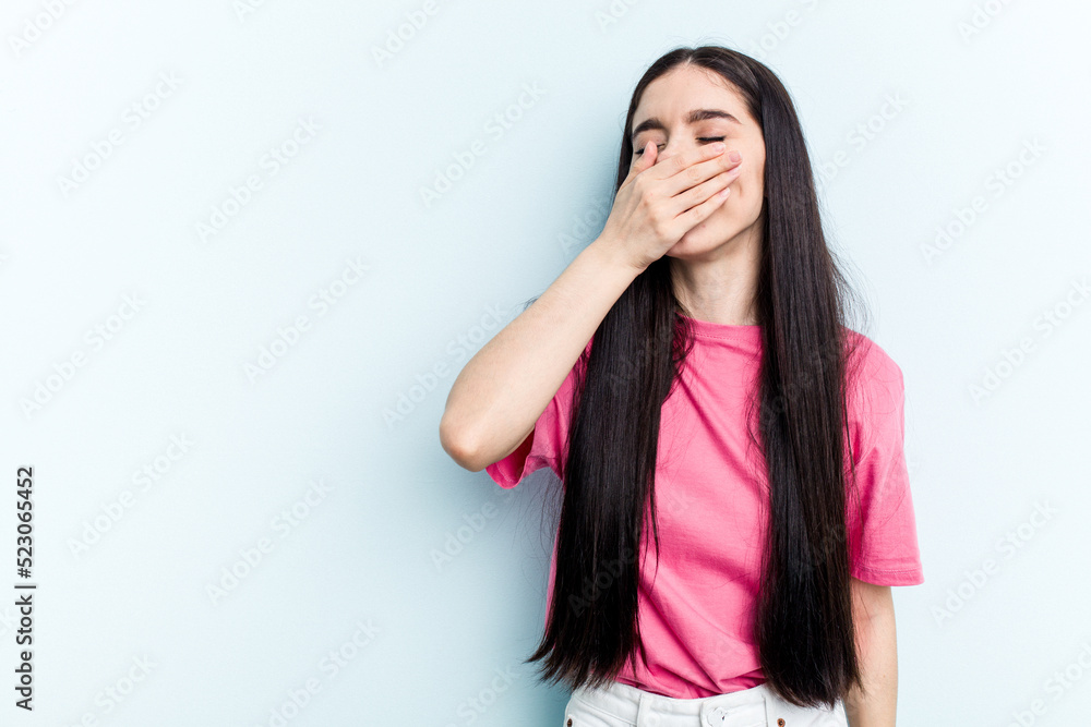 Young caucasian woman isolated on blue background laughing happy, carefree, natural emotion. Young caucasian woman isolated on blue background laughing happy, carefree, natural emotion.