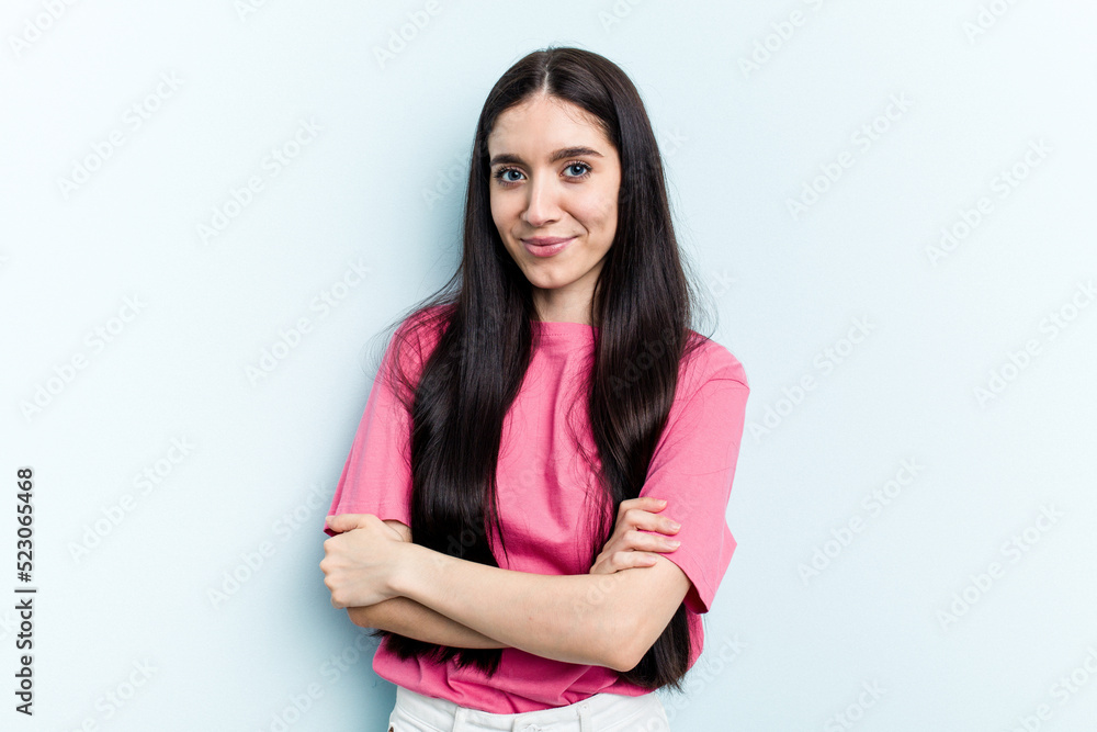 Young caucasian woman isolated on blue background happy, smiling and cheerful. Young caucasian woman isolated on blue background happy, smiling and cheerful.