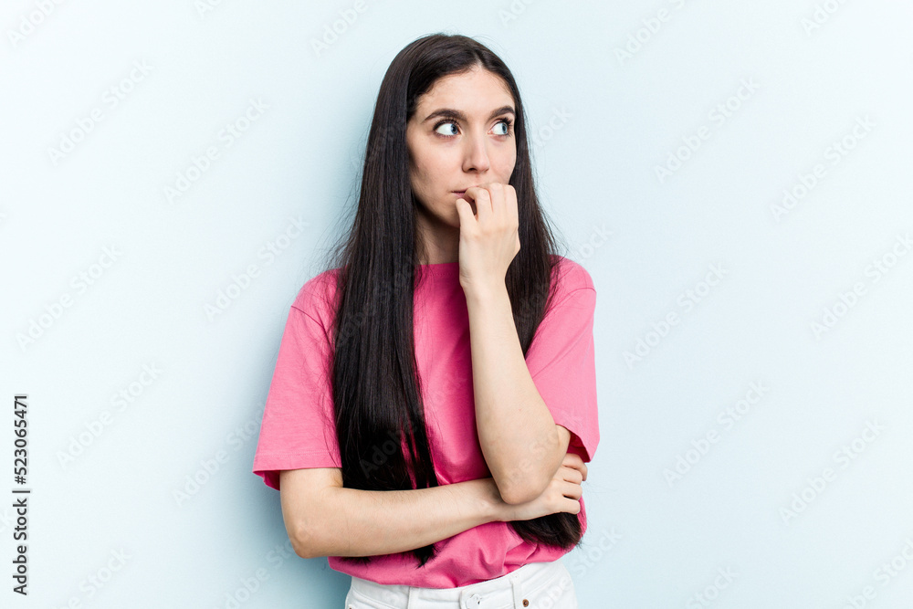 Young caucasian woman isolated on blue background biting fingernails, nervous and very anxious. Young caucasian woman isolated on blue background biting fingernails, nervous and very anxious.