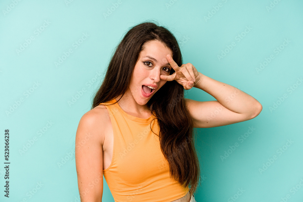 Young caucasian woman isolated on blue background dancing and having fun.