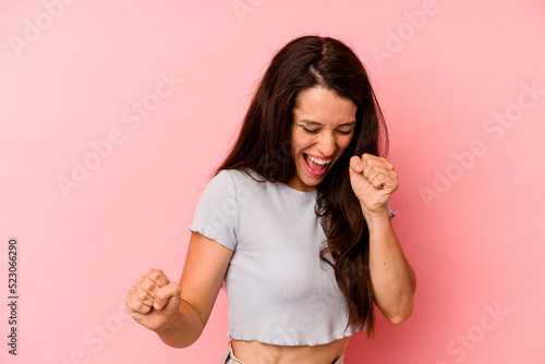 Young caucasian woman isolated on pink background dancing and having fun.