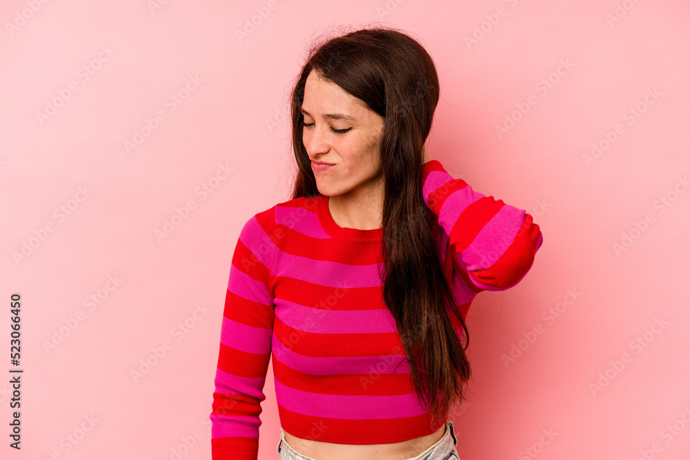 Young caucasian woman isolated on pink background having a neck pain due to stress, massaging and touching it with hand. Young caucasian woman isolated on pink background having a neck pain due to stress, massaging and touching it with hand.