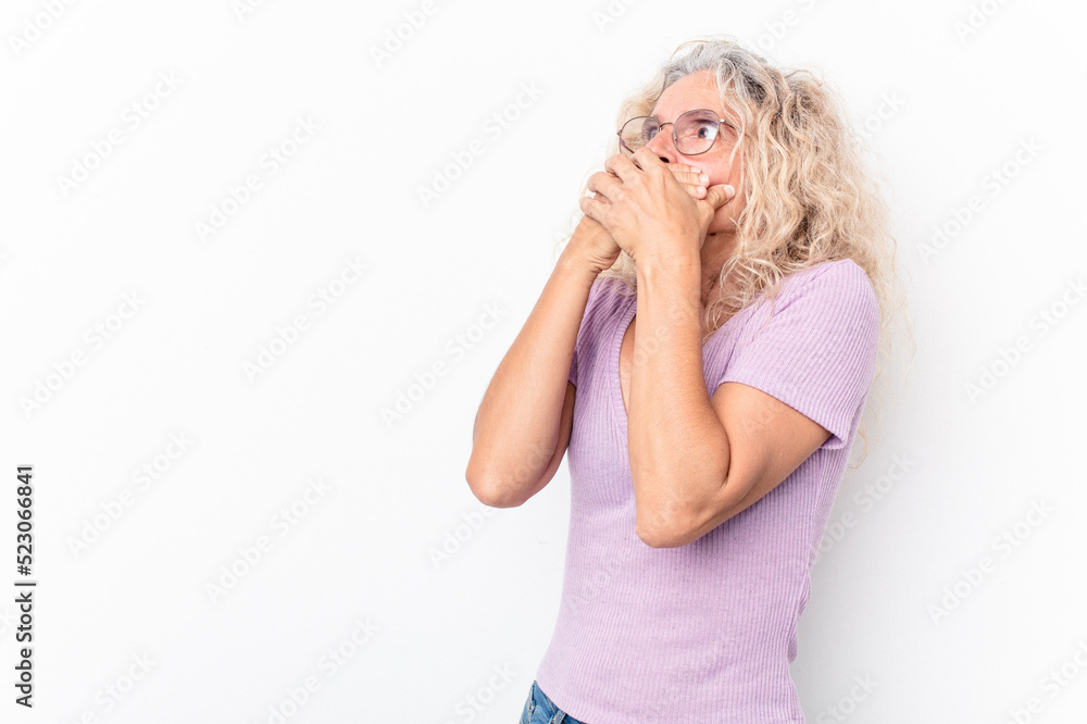 Middle age caucasian woman isolated on white background thoughtful looking to a copy space covering mouth with hand. Middle age caucasian woman isolated on white background thoughtful looking to a copy space covering mouth with hand.