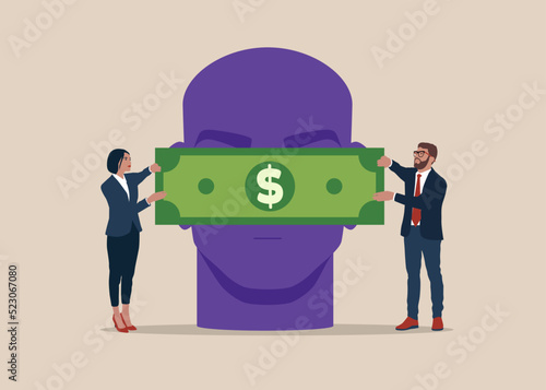 Businesswoman and businessman with cash money dollar banknote covering the eyes of a businessman. Bribery concept. 