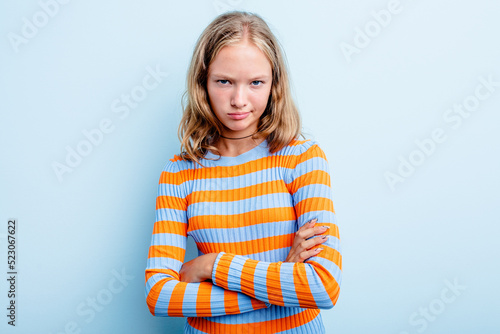 Caucasian teen girl isolated on blue background unhappy looking in camera with sarcastic expression.