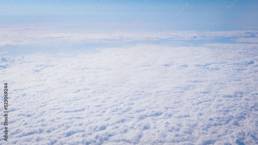 Fluffy clouds that looks as flat surface as seen from commercial airplane Fluffy clouds that looks as flat surface as seen from commercial airplane