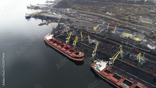 Port filled with coal, waiting for ships to start loading. Murmansk, Russia. Drone view