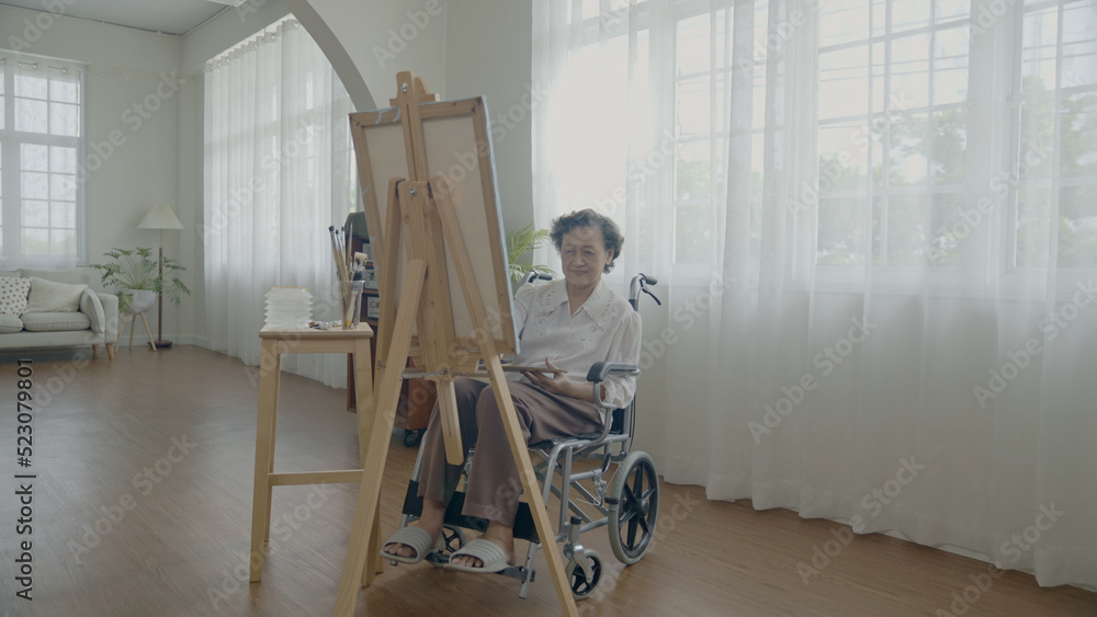 Artist concept of 4k Resolution. Asian woman drawing in the living room. Artist is creating work. People with disabilities are creating hobbies.
