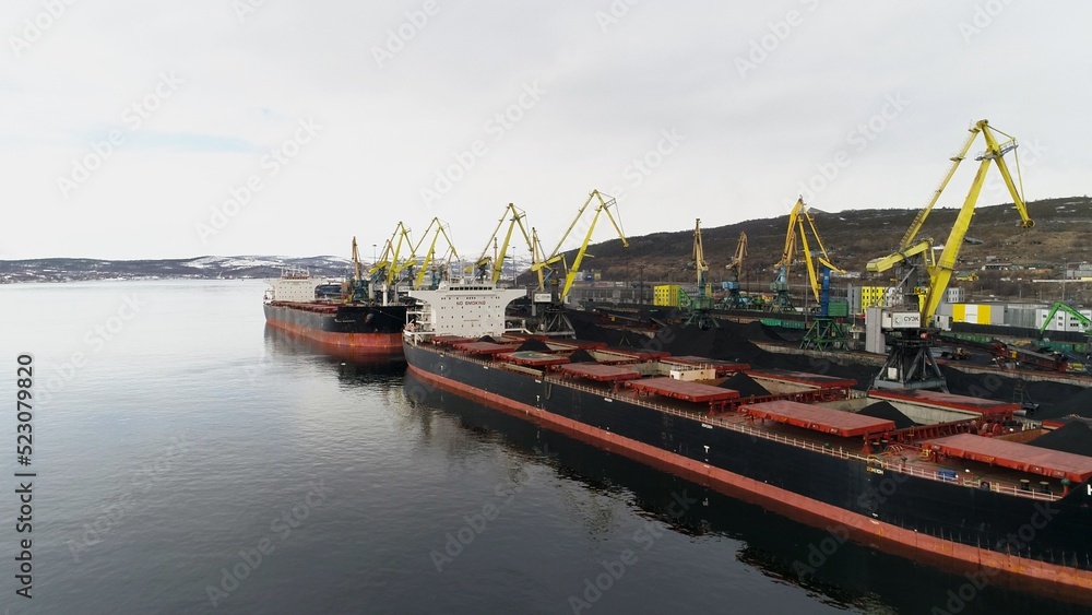 View of Murmansk and part of seaport intended for loading coal. View from camera on drone from sea side