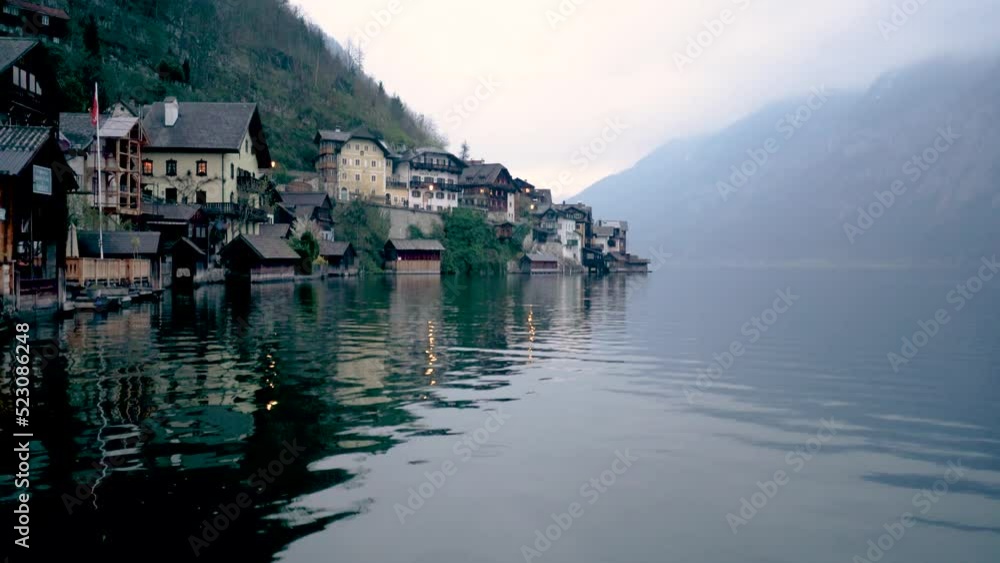 Hallstatt alps famous church tower and lake mountains clouds Hallstatt alps famous church tower and lake mountains clouds