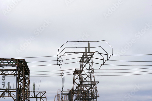 Electricity station and power lines under gray cloudy sky
