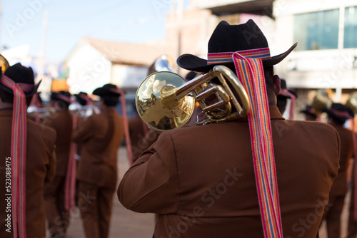 Músico tocando el Trombón en una fiesta patronal en Perú. Concepto de tradiciones y cultura. photo