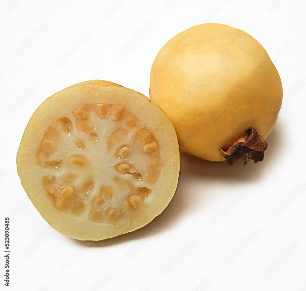 Cut guavas (Psidium guajava) on white background.