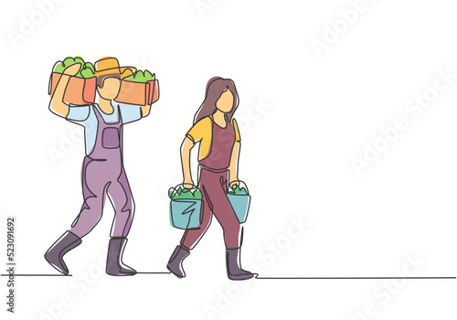 Continuous one line drawing couple farmer carrying boxes and baskets of fruit in they right and left hands and shouldered it. Minimalist concept. Single line draw design vector graphic illustration.