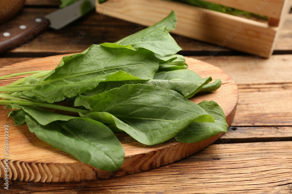 Fresh green sorrel leaves on wooden table, closeup Fresh green sorrel leaves on wooden table, closeup