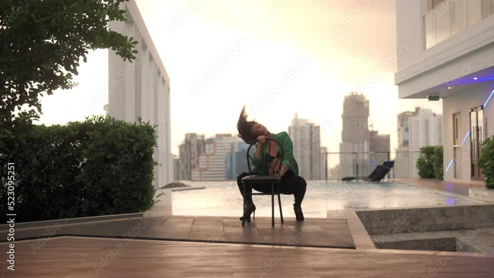 Woman Crouching And Dancing In High Heels And Bra At Poolside Woman Crouching And Dancing In High Heels And Bra At Poolside