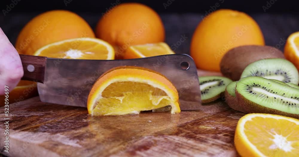 chop an orange into pieces on a wooden chopping board, cooking food and desserts from ripe citrus orange chop an orange into pieces on a wooden chopping board, cooking food and desserts from ripe citrus orange