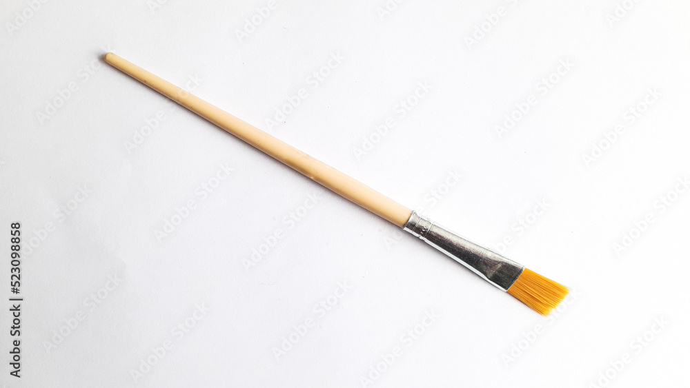 Top view of a variety of artist brushes on a white background with copy space for text. Creative postcard. Top view of a variety of artist brushes on a white background with copy space for text. Creative postcard.