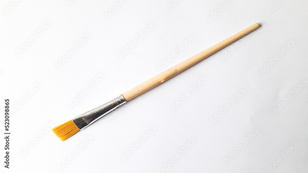 Top view of a variety of artist brushes on a white background with copy space for text. Creative postcard.