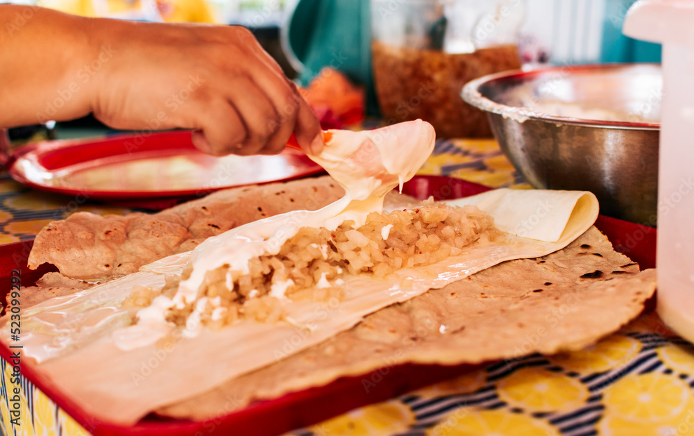 Hands making Nicaraguan Quesillo. Central American food the Quesillo, View of the traditional Quesillo with pickled onion, Preparation of the Traditional Nicaraguan Quesillo