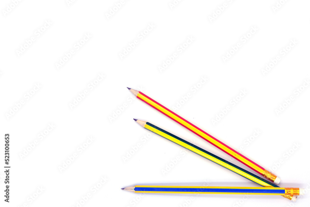 multi colored pencils placed on a white background multi colored pencils placed on a white background