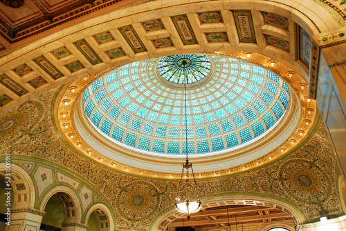 A large stained glass window, designed by Tiffany, hovers over the main atrium and lobby or the ornate and historic Chicago Cultural Center photo
