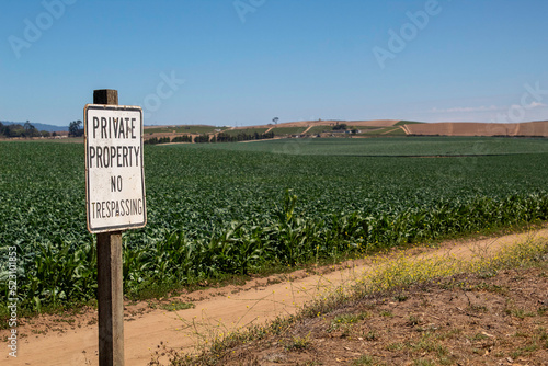 Private Property no trespassing sign on farm land photo