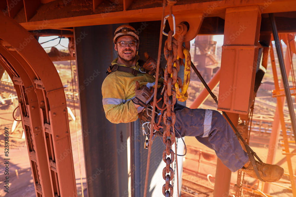 Happy maintenance inspector rope access worker rigger wearing full body