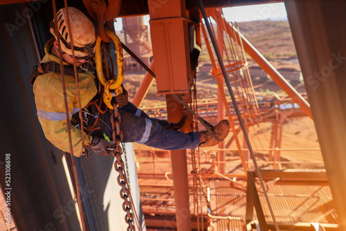 Fotografia Rope access rigger wearing fall body safety harness abseiling hanging on twin ro