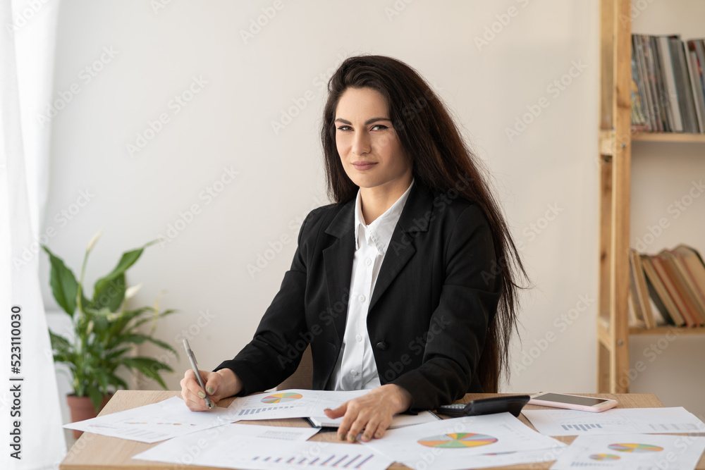 Businesswoman using calculator for finance math in office and business, tax, accounting, statistics and analytical research Businesswoman using calculator for finance math in office and business, tax, accounting, statistics and analytical research