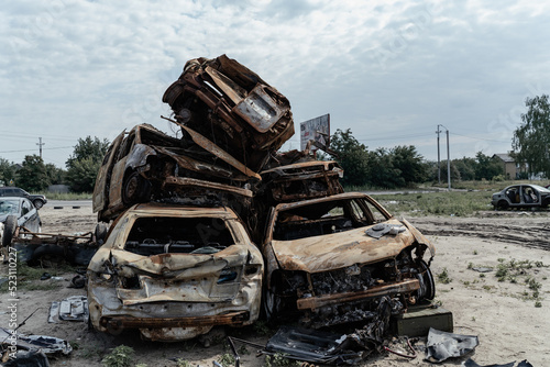 15.07.2022 Bucha Burnt and blown up car. Cars damaged after shelling. Traces of shots on the body of the car. War between Russia and Ukraine, Kyiv region - Bucha