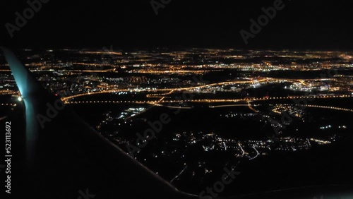 Airplane flight over the night city. View from the airplane window.