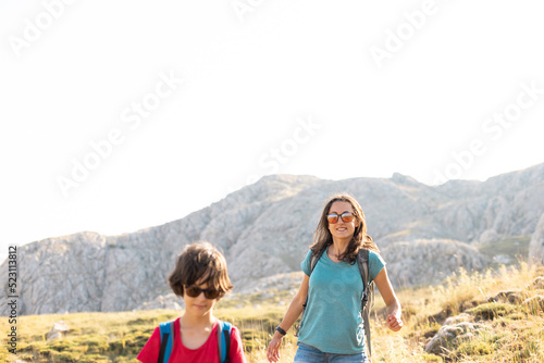 mother with a child on a hike walk along the road