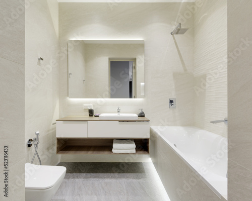 bathroom with beige tiles with stone texture  modern bathroom interior