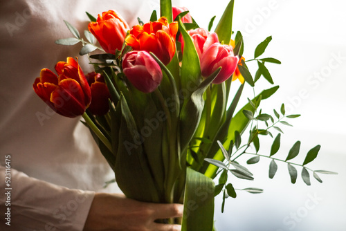 Fototapeta Naklejka Na Ścianę i Meble -  A bright bouquet of tulips in your hand