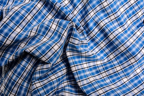 Blue gingham tablecloth background or texture .