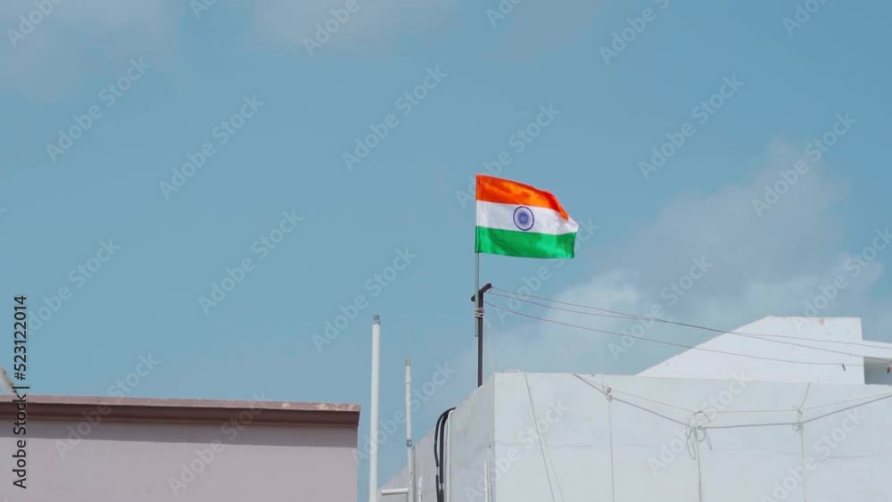 India flag. Indian flag displaying on a pole on top of the house. Slow