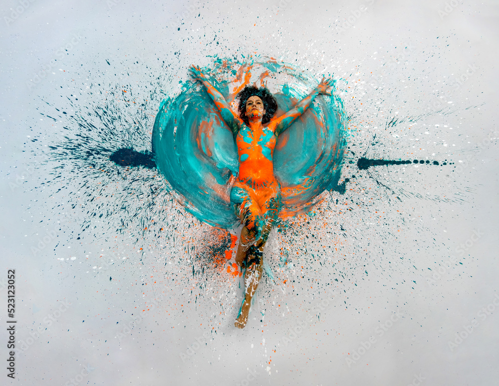 top view to expressive sexy naked woman lying elegant on the floor in turquoise blue orange