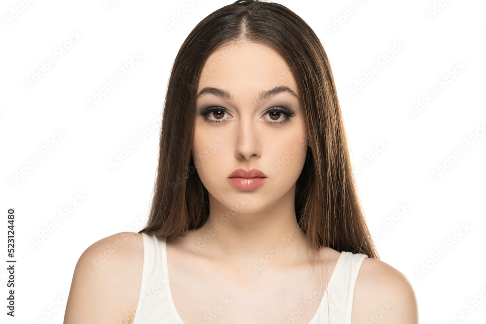 beautiful young serious women with makeup on a white studio background. beautiful young serious women with makeup on a white studio background.