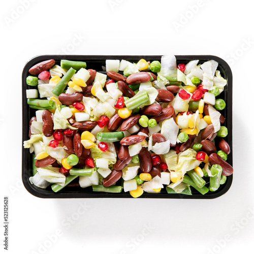 Vegetable Fruit Salad in black plastic bowl against plain background