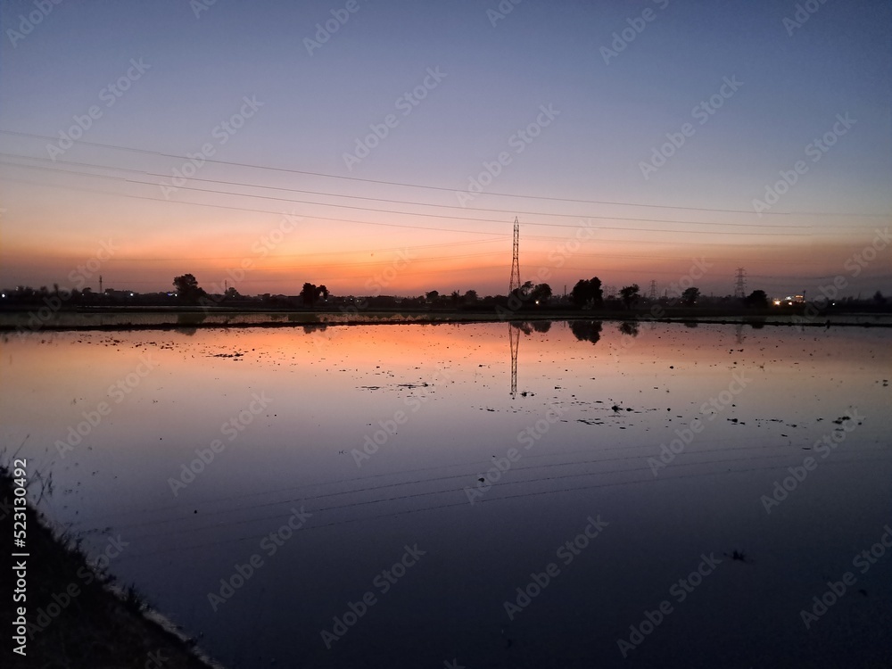 sunset and its reflection in water