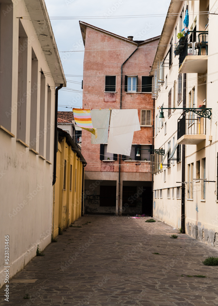Charming narrow street and laundry hung to dry in Venice, Italy