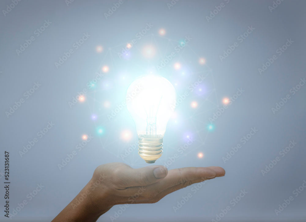 Innovative ideas, lightbulb on hand, concept for creating new things. Finding inspiration to improve or develop marketing and business Innovative ideas, lightbulb on hand, concept for creating new things. Finding inspiration to improve or develop marketing and business